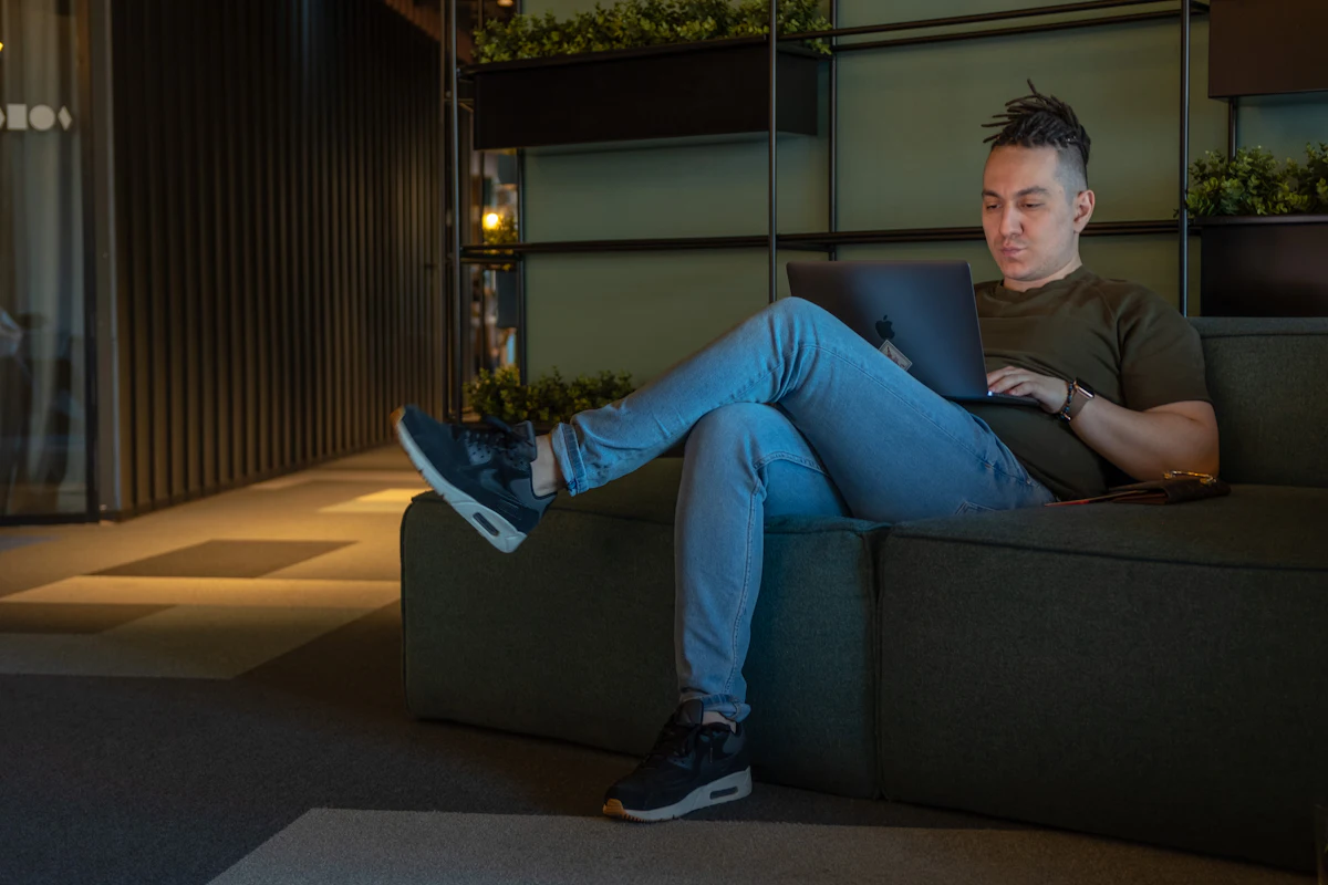 Man kijkt IPTV Smarters Pro op zijn Windows-laptop op de bank